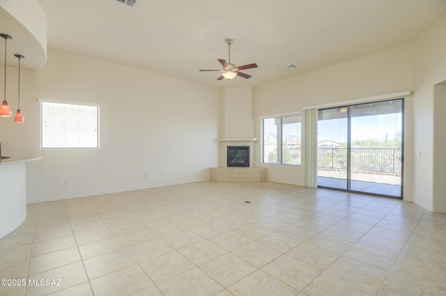 11626 N Moon Ranch Pl, Marana, AZ 85658 - unfurnished living room featuring light tile patterned floors, visible vents, ceiling fan, and a tiled fireplace