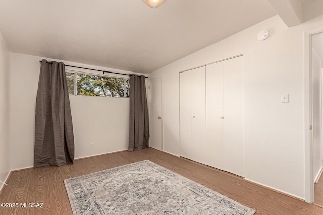 7267 E Eastview Dr, Tucson, AZ 85710 - unfurnished bedroom featuring wood finished floors and a closet