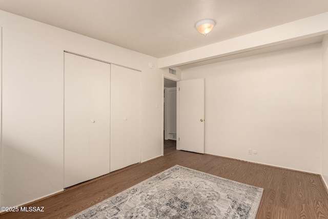7267 E Eastview Dr, Tucson, AZ 85710 - unfurnished bedroom featuring wood finished floors and a closet
