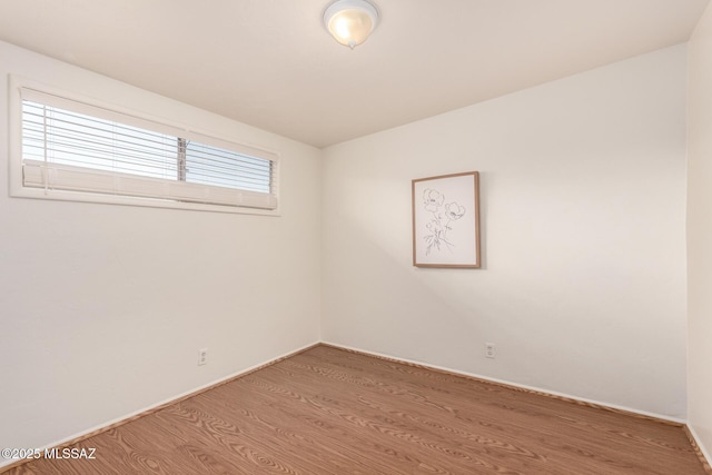 7267 E Eastview Dr, Tucson, AZ 85710 - spare room with wood finished floors and baseboards