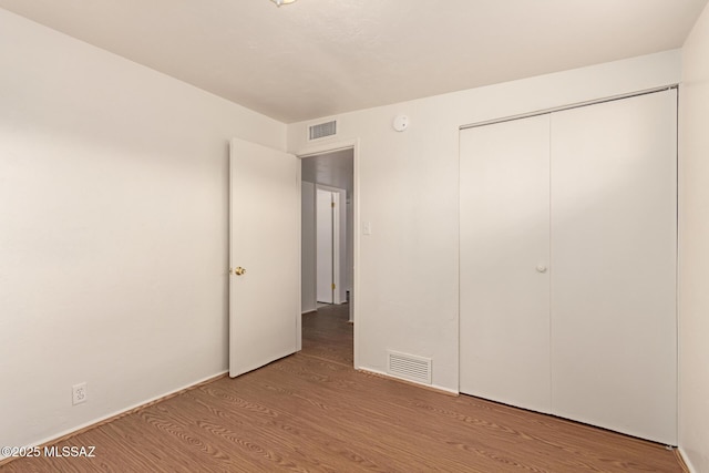 7267 E Eastview Dr, Tucson, AZ 85710 - unfurnished bedroom featuring wood finished floors and a closet