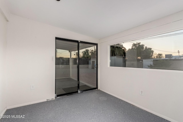 7267 E Eastview Dr, Tucson, AZ 85710 - spare room featuring speckled floor and baseboards