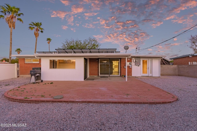 7267 E Eastview Dr, Tucson, AZ 85710 - back of property featuring a patio area, a fenced backyard, and brick siding