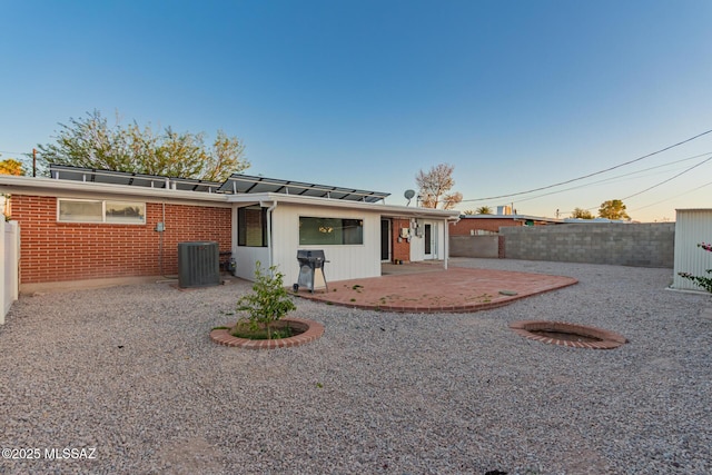 7267 E Eastview Dr, Tucson, AZ 85710 - rear view of property featuring a patio, a fenced backyard, central AC unit, and brick siding