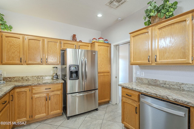 1117 E Regent Dr, Oro Valley, AZ 85755 - kitchen with light tile patterned floors, visible vents, light stone countertops, and appliances with stainless steel finishes