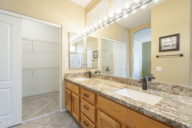 1117 E Regent Dr, Oro Valley, AZ 85755 - full bath with double vanity, tile patterned floors, a spacious closet, and a sink