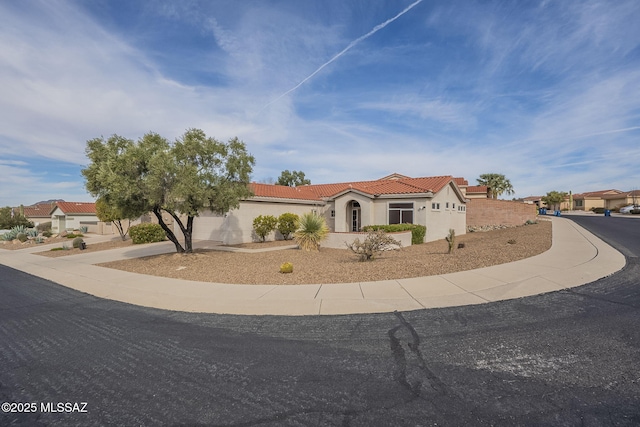 1117 E Regent Dr, Oro Valley, AZ 85755 - mediterranean / spanish-style house featuring concrete driveway, a tiled roof, and stucco siding
