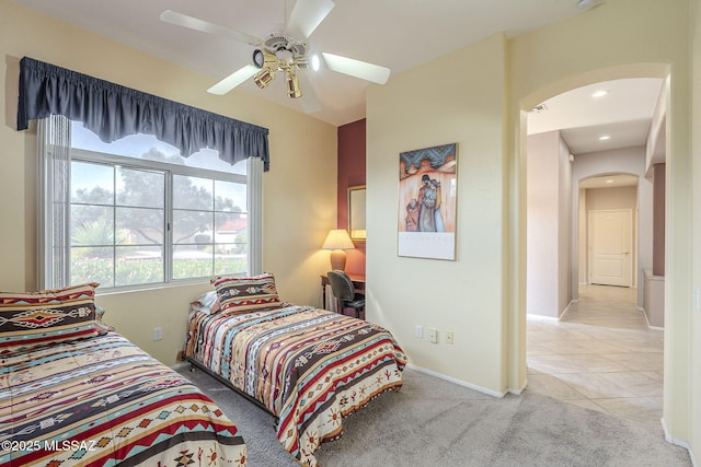 1117 E Regent Dr, Oro Valley, AZ 85755 - bedroom with a ceiling fan, light tile patterned flooring, recessed lighting, arched walkways, and light carpet