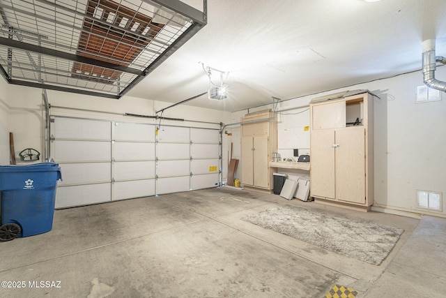 1117 E Regent Dr, Oro Valley, AZ 85755 - garage with visible vents and a garage door opener