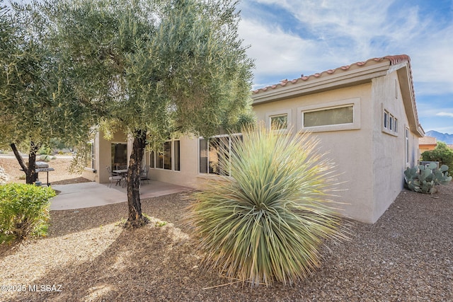 1117 E Regent Dr, Oro Valley, AZ 85755 - back of house featuring a tiled roof, a patio area, and stucco siding