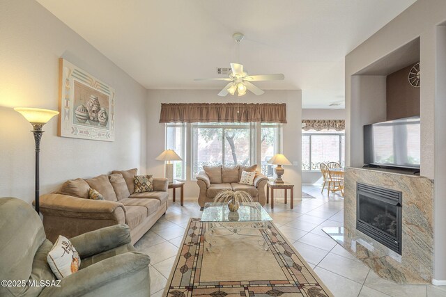1117 E Regent Dr, Oro Valley, AZ 85755 - living room with light tile patterned floors, a fireplace, baseboards, and ceiling fan