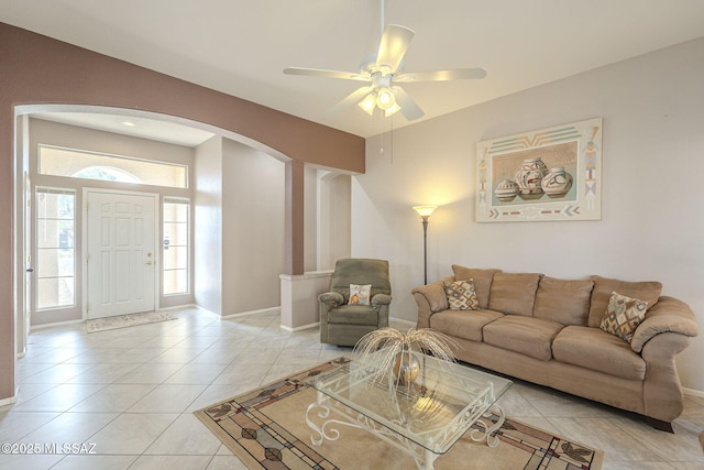 1117 E Regent Dr, Oro Valley, AZ 85755 - living room with light tile patterned floors, baseboards, arched walkways, and ceiling fan