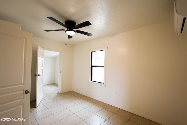 empty room featuring light tile patterned flooring and a ceiling fan