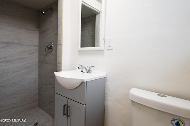 full bath with vanity and a tile shower