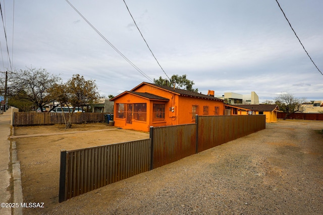 view of side of home with a fenced front yard
