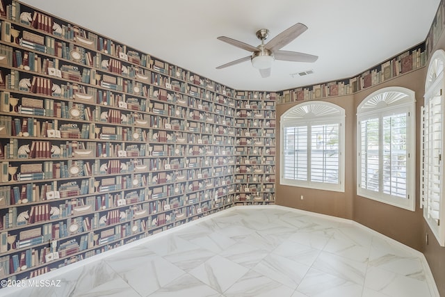 unfurnished room featuring ceiling fan, baseboards, and visible vents