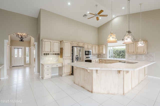 kitchen with high vaulted ceiling and light brown cabinetry