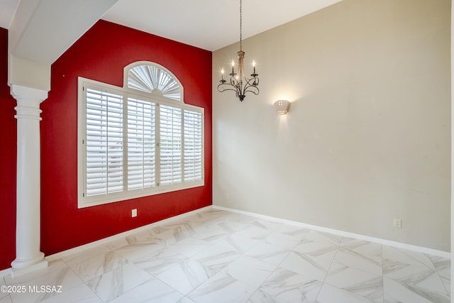 unfurnished room with marble finish floor, baseboards, a notable chandelier, and ornate columns