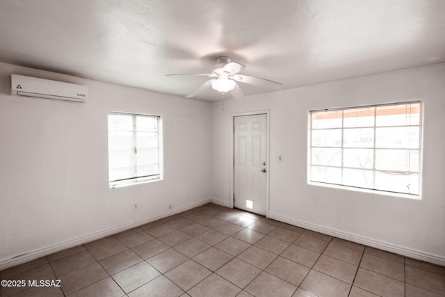 unfurnished room with light tile patterned floors, baseboards, ceiling fan, and a wall mounted AC