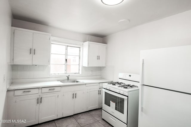 kitchen with a sink, backsplash, white cabinetry, white appliances, and light countertops