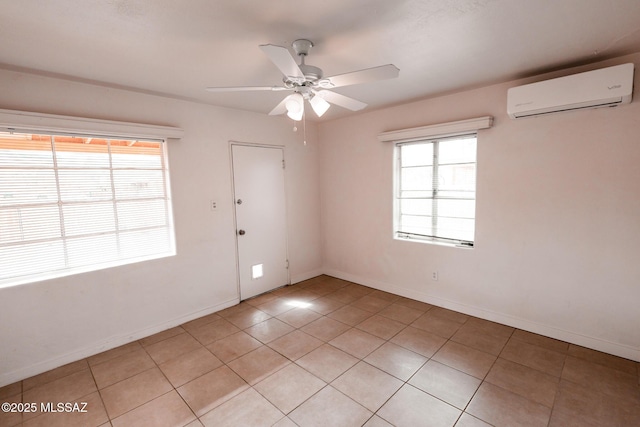 unfurnished room with light tile patterned floors, baseboards, a ceiling fan, and a wall mounted AC