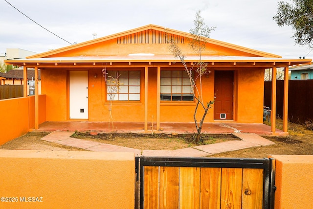 view of front of property featuring a fenced front yard and stucco siding