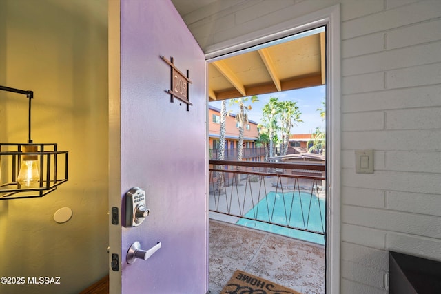 doorway to outside with tile patterned floors