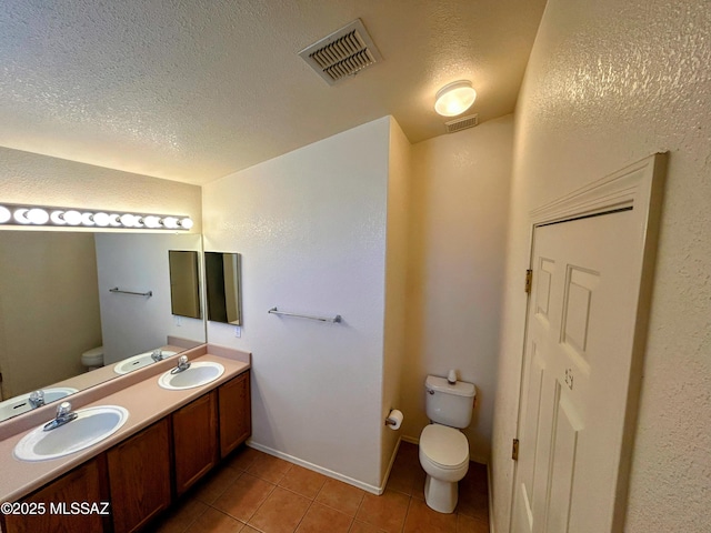 full bathroom with a sink, visible vents, toilet, and tile patterned floors