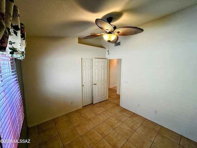 unfurnished bedroom featuring visible vents, tile patterned floors, and ceiling fan