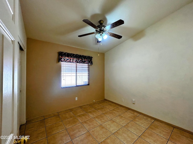 unfurnished bedroom featuring a closet, light tile patterned flooring, baseboards, and a ceiling fan