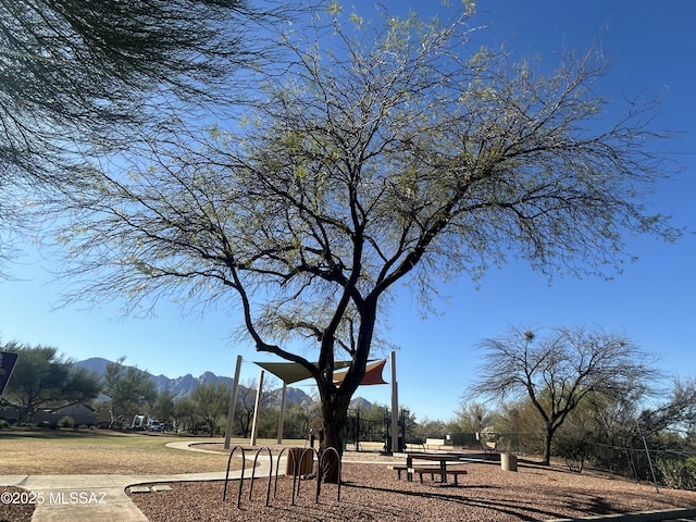 surrounding community featuring a mountain view and playground community