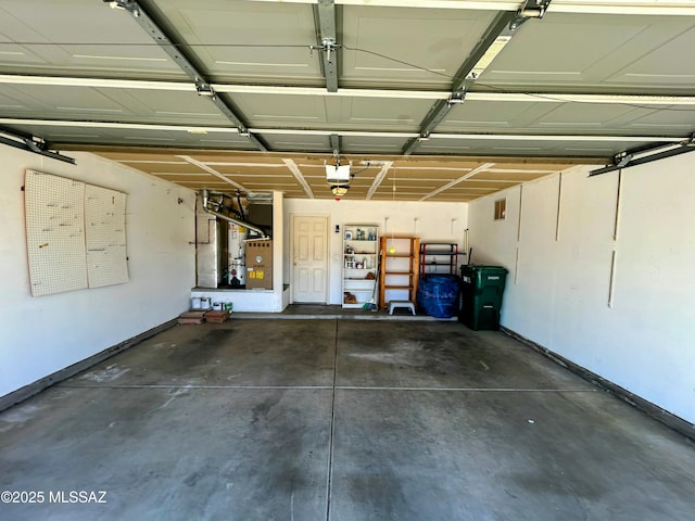 garage with baseboards, heating unit, and a garage door opener