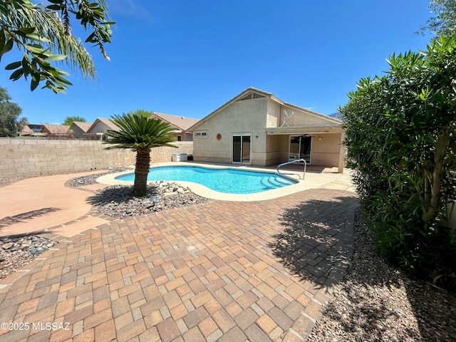 view of swimming pool with a patio area, a fenced in pool, and fence