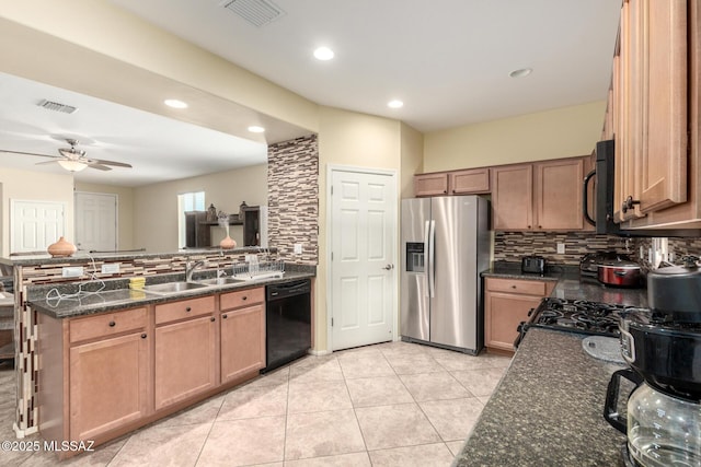 7483 S Salt Water Dr, Tucson, AZ 85757 - kitchen with visible vents, black appliances, a sink, dark stone countertops, and a peninsula