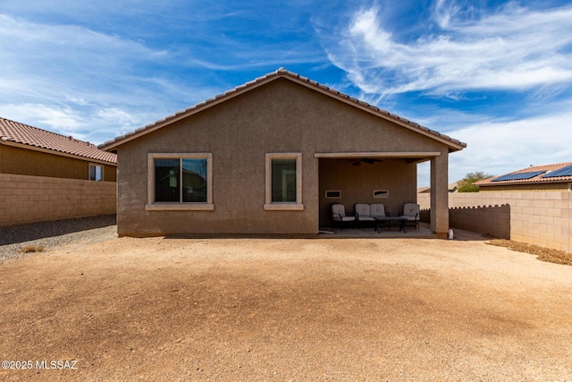 7483 S Salt Water Dr, Tucson, AZ 85757 - back of property with a fenced backyard, stucco siding, a patio, and ceiling fan