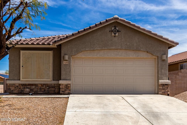 7483 S Salt Water Dr, Tucson, AZ 85757 - view of front of home with a tile roof, concrete driveway, stucco siding, a garage, and stone siding