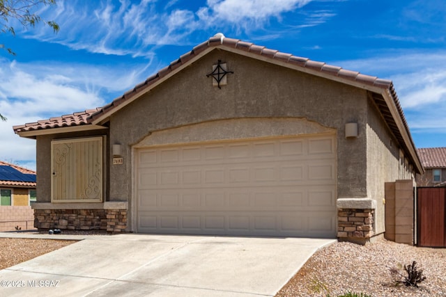 7483 S Salt Water Dr, Tucson, AZ 85757 - view of front of home with stucco siding, concrete driveway, a garage, stone siding, and a tile roof