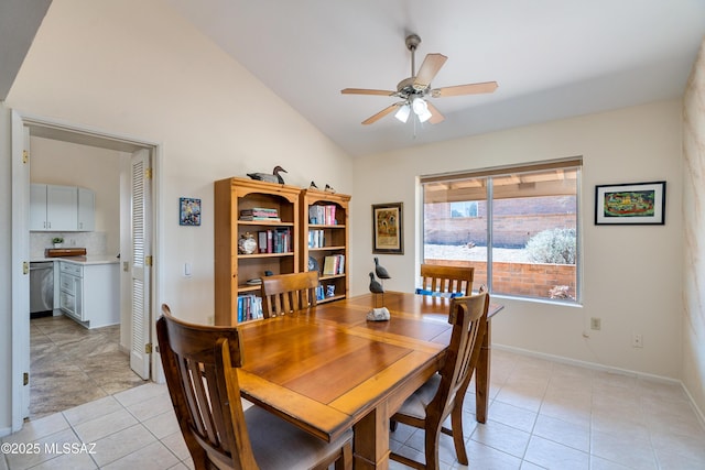 dining area with vaulted ceiling, light tile patterned floors, a ceiling fan, and baseboards