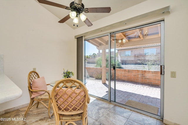 dining room featuring baseboards, a ceiling fan, and vaulted ceiling
