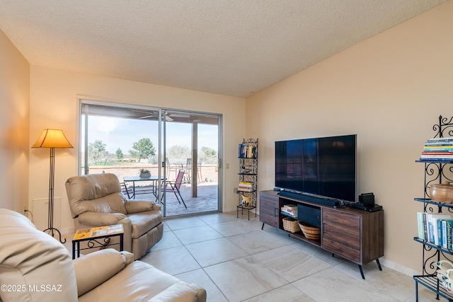 living area with a textured ceiling and baseboards