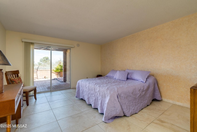 bedroom featuring access to outside and baseboards