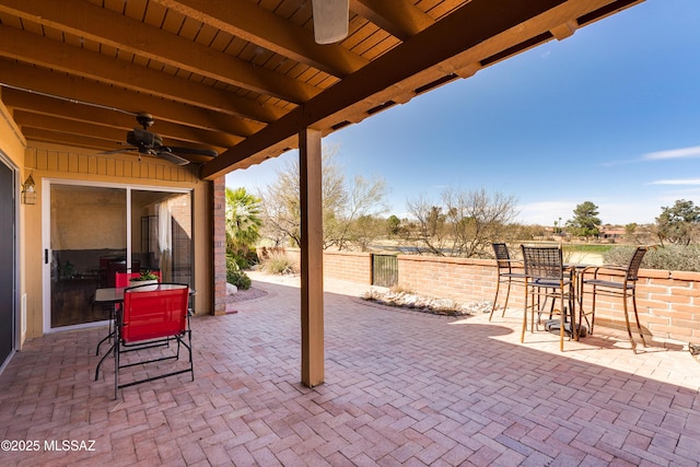 view of patio with ceiling fan and fence