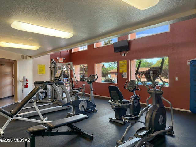 5051 N Sabino Canyon Rd Unit 1152, Tucson, AZ 85750 - gym featuring a textured ceiling, plenty of natural light, and baseboards