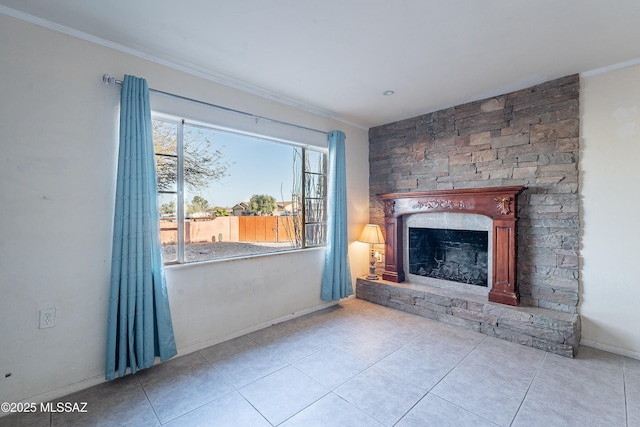 unfurnished living room with a stone fireplace, tile patterned flooring, and ornamental molding