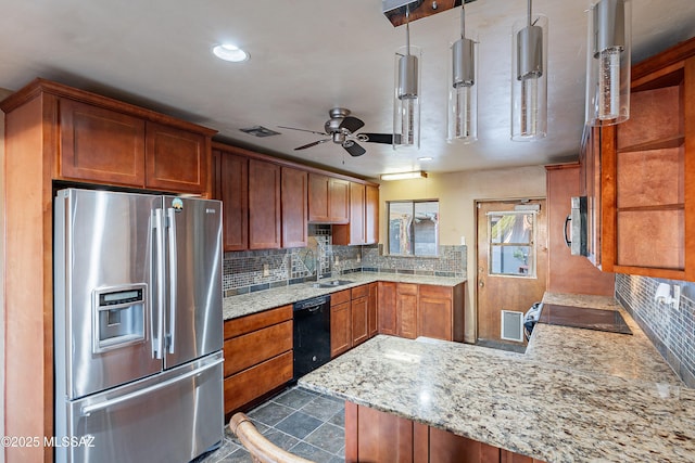 kitchen featuring brown cabinets, backsplash, appliances with stainless steel finishes, a peninsula, and ceiling fan
