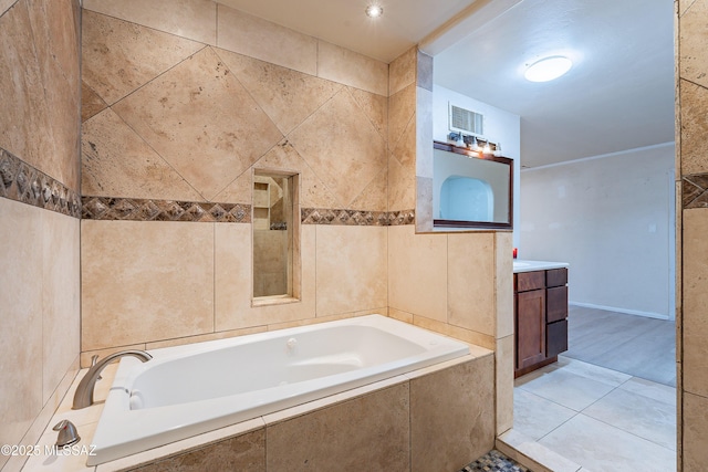 full bathroom featuring tile patterned flooring, visible vents, tile walls, and a garden tub