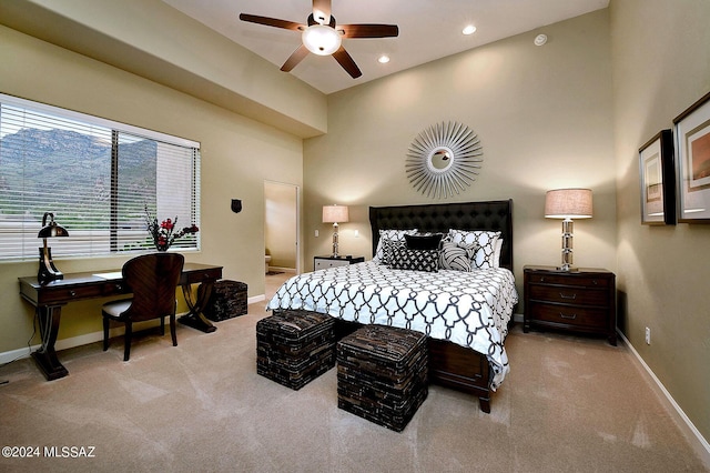 bedroom featuring a ceiling fan, recessed lighting, carpet floors, a high ceiling, and baseboards
