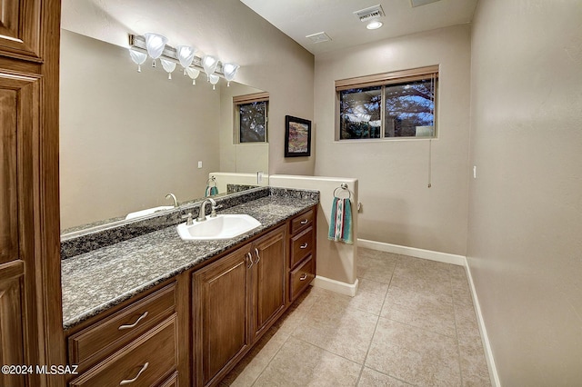bathroom with vanity, tile patterned floors, baseboards, and visible vents