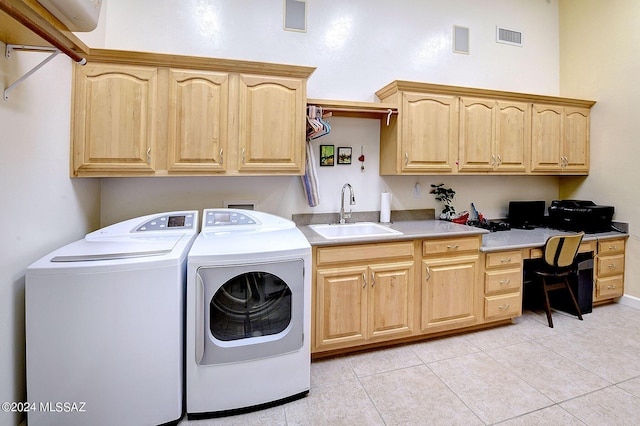 clothes washing area featuring visible vents, light tile patterned floors, washer and dryer, cabinet space, and a sink