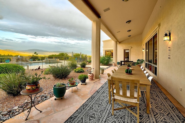 view of patio / terrace featuring a mountain view and fence